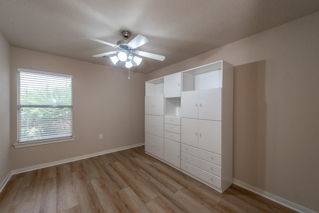 5242 Garnetfield Ln, Katy, TX 77494 - unfurnished bedroom featuring light wood finished floors and a ceiling fan