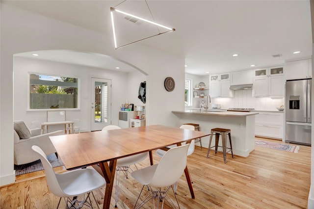 1039 Lamonte Ln, Houston, TX 77018 - dining room featuring arched walkways, light wood-type flooring, and recessed lighting