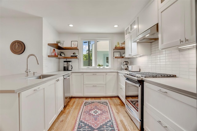 1039 Lamonte Ln, Houston, TX 77018 - kitchen with stainless steel appliances, open shelves, under cabinet range hood, light wood-style flooring, and recessed lighting