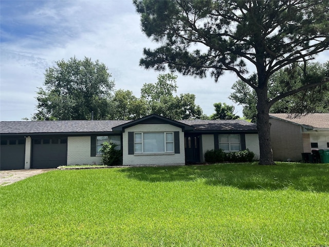 1207 Dwinnell St, Baytown, TX 77520 - ranch-style house featuring brick siding, a garage, a front lawn, driveway, and roof with shingles