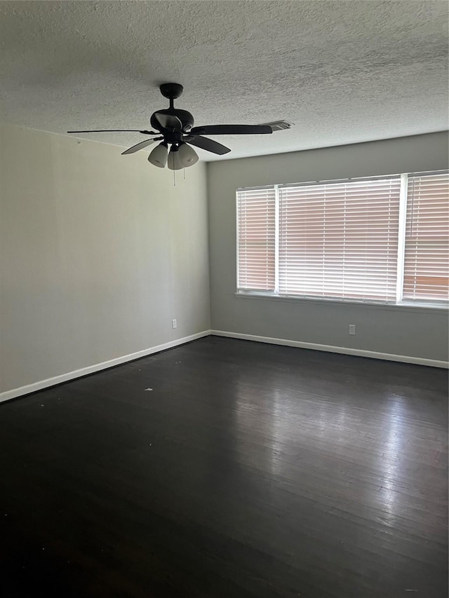 1207 Dwinnell St, Baytown, TX 77520 - empty room with a ceiling fan, wood finished floors, and a textured ceiling