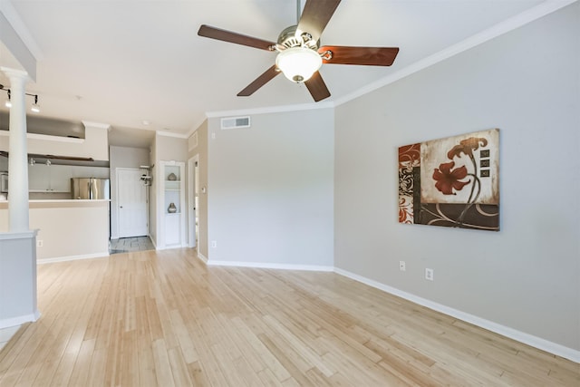 1330 Old Spanish Trl Unit 1210, Houston, TX 77054 - unfurnished living room featuring decorative columns, wood finished floors, ceiling fan, and ornamental molding