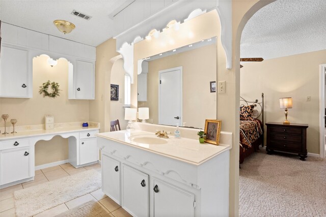 2306 Westfield St, Alvin, TX 77511 - ensuite bathroom featuring vanity, a textured ceiling, and tile patterned floors