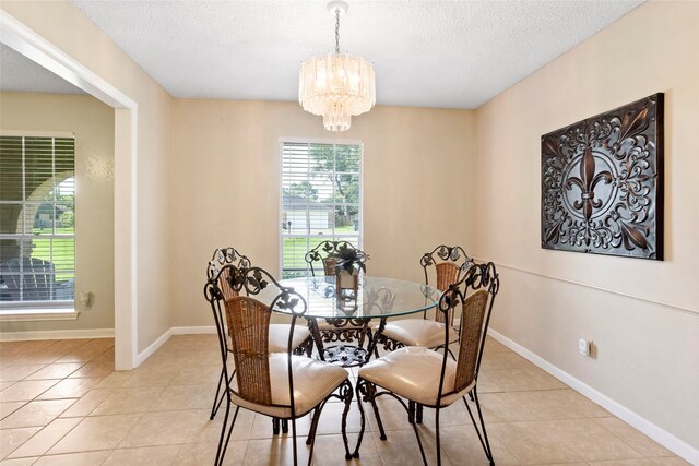 2306 Westfield St, Alvin, TX 77511 - dining area featuring a chandelier, light tile patterned floors, and a textured ceiling