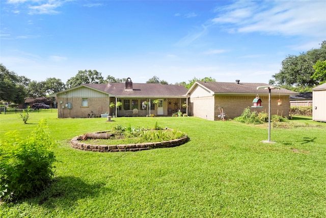 2306 Westfield St, Alvin, TX 77511 - back of property with brick siding and a chimney