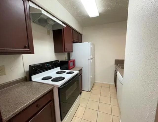 10555 Turtlewood Ct Unit 2303, Houston, TX 77072 - kitchen featuring white appliances, light tile patterned flooring, a textured wall, range hood, and dark countertops
