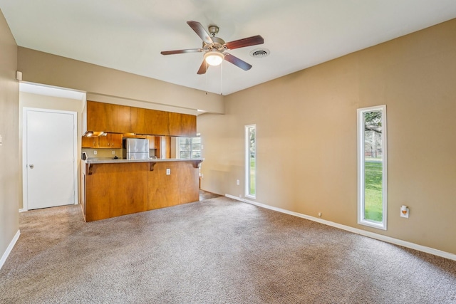 5302 Pine Ave, Pasadena, TX 77503 - unfurnished living room with a ceiling fan and light colored carpet