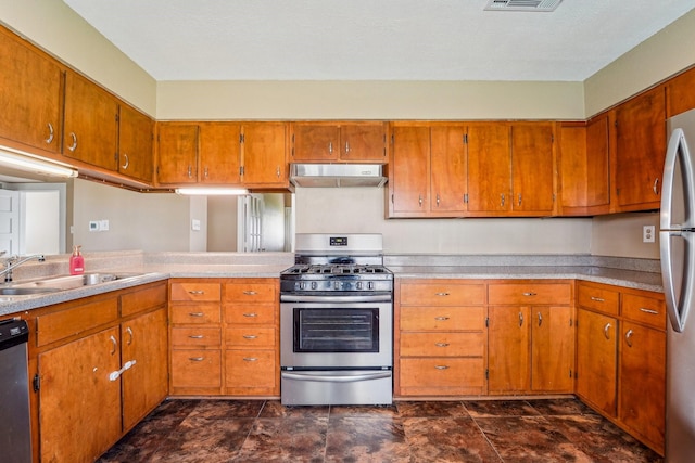5302 Pine Ave, Pasadena, TX 77503 - kitchen featuring appliances with stainless steel finishes, under cabinet range hood, and brown cabinetry