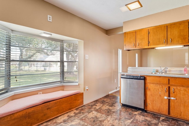 5302 Pine Ave, Pasadena, TX 77503 - kitchen with stainless steel dishwasher, light countertops, brown cabinets, and stone finish floors