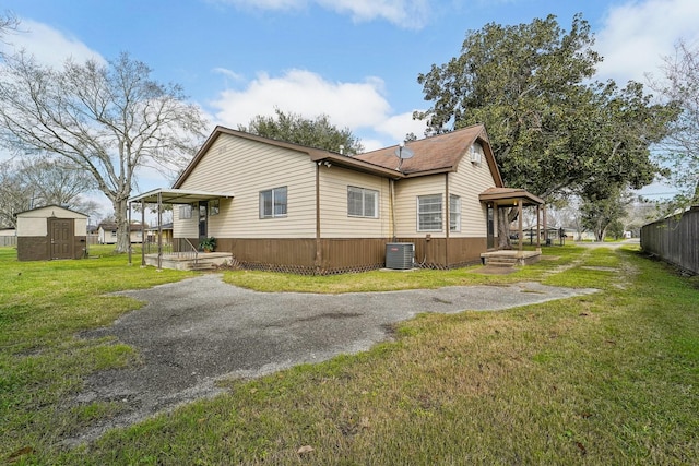 5302 Pine Ave, Pasadena, TX 77503 - view of side of property featuring a shed and asphalt driveway