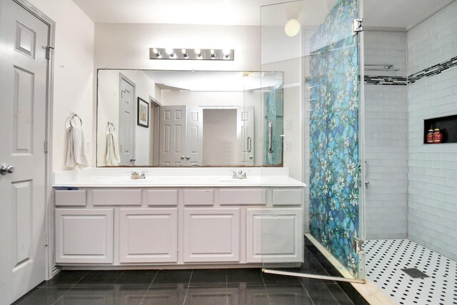 14710 Branchwest Dr, Houston, TX 77082 - bathroom featuring a tile shower, double vanity, and tile patterned floors