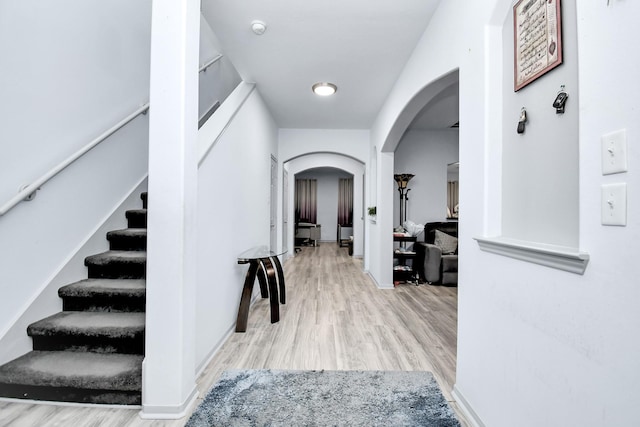 14710 Branchwest Dr, Houston, TX 77082 - hall with arched walkways, wood finished floors, and stairway
