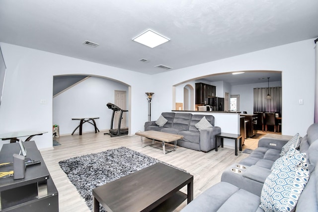 14710 Branchwest Dr, Houston, TX 77082 - living area featuring arched walkways and light wood finished floors