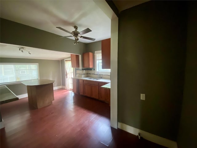 212 Harding Ave, Cleveland, TX 77327 - kitchen featuring a ceiling fan, dark wood-style floors, light countertops, and brown cabinets