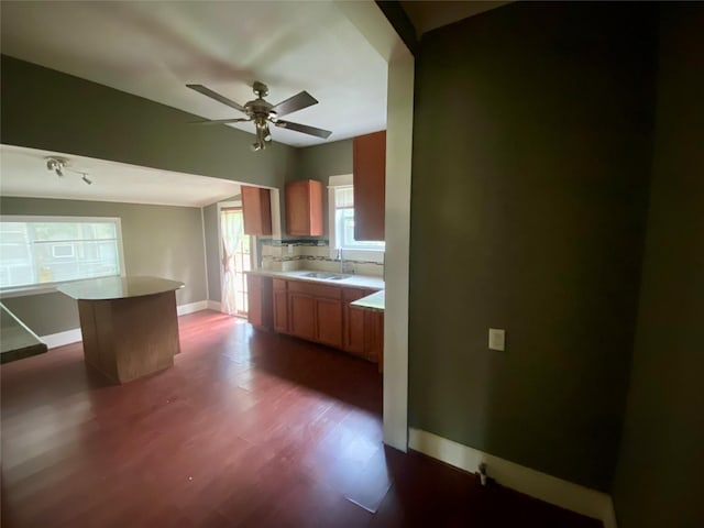 212 Harding Ave, Cleveland, TX 77327 - kitchen featuring ceiling fan, a kitchen island, dark wood finished floors, and light countertops