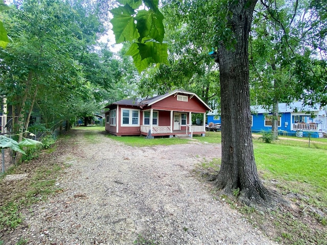 212 Harding Ave, Cleveland, TX 77327 - view of front of house featuring driveway, a porch, and a front yard