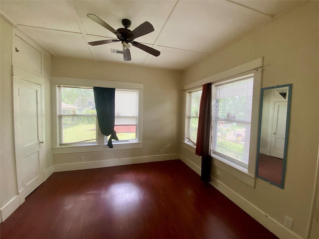 212 Harding Ave, Cleveland, TX 77327 - unfurnished room featuring dark wood-type flooring, plenty of natural light, and a ceiling fan