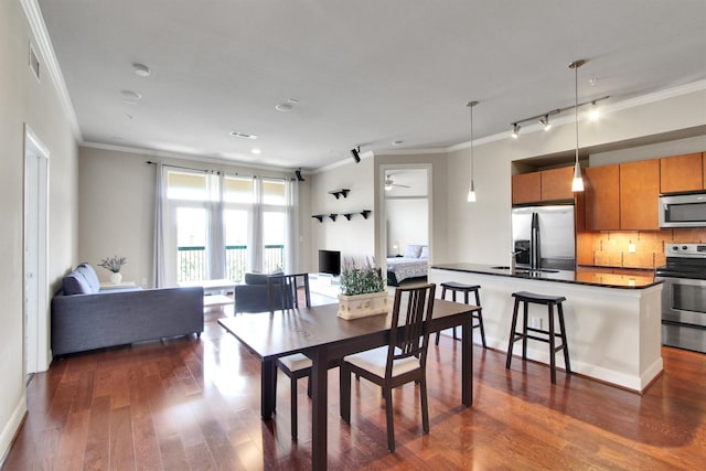 300 St Joseph Pkwy Unit 318, Houston, TX 77002 - dining area featuring crown molding and dark wood-type flooring