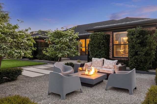 9718 Checkerboard St, Houston, TX 77096 - patio terrace at dusk with a patio area and an outdoor living space with a fire pit