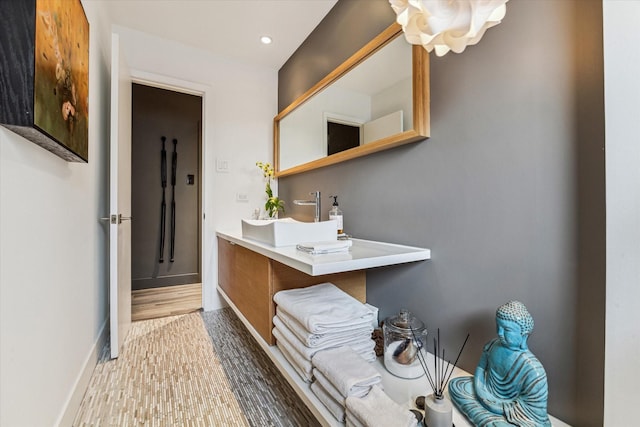 9718 Checkerboard St, Houston, TX 77096 - bathroom with wood finished floors, vanity, and recessed lighting
