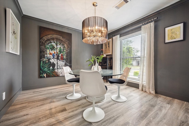 9718 Checkerboard St, Houston, TX 77096 - dining space with a chandelier, ornamental molding, and wood finished floors