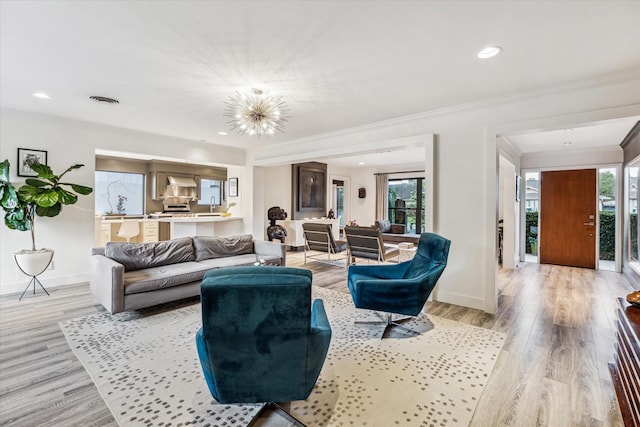 9718 Checkerboard St, Houston, TX 77096 - living area featuring healthy amount of natural light, a chandelier, light wood finished floors, crown molding, and recessed lighting