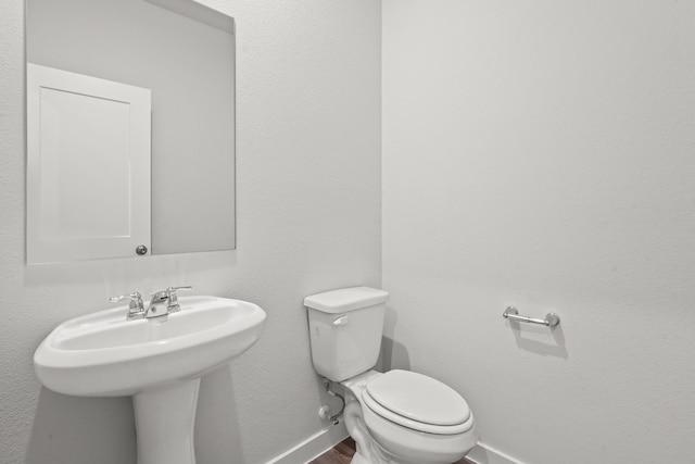 316 Amy St, Angleton, TX 77515 - half bathroom featuring baseboards and wood finished floors