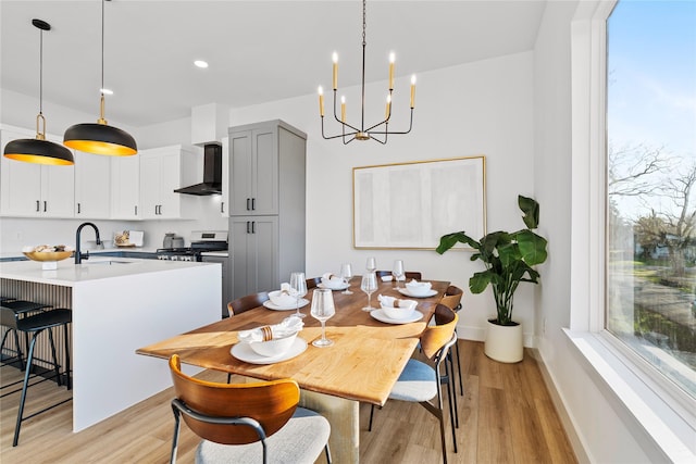 6907 Conley St, Houston, TX 77021 - dining space with light wood finished floors, a chandelier, and recessed lighting