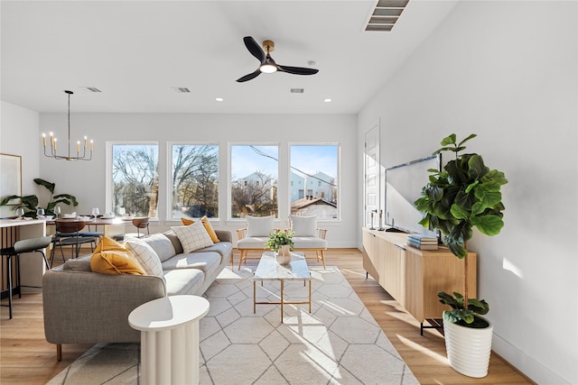 6907 Conley St, Houston, TX 77021 - living area featuring light wood-type flooring, a chandelier, a ceiling fan, and recessed lighting
