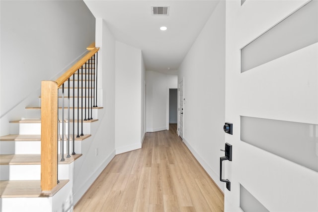 6907 Conley St, Houston, TX 77021 - hallway featuring light wood finished floors, stairway, and recessed lighting