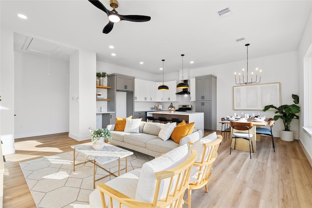 6907 Conley St, Houston, TX 77021 - living room featuring attic access, ceiling fan, light wood-style floors, recessed lighting, and a chandelier