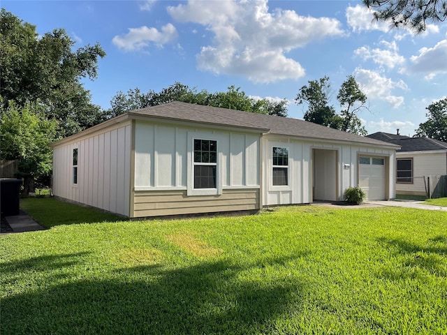 8766 Flossie Mae St, Houston, TX 77029 - view of front of home with board and batten siding, a garage, a front yard, driveway, and a shingled roof