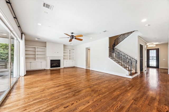 1901 Woodcrest Dr, Houston, TX 77018 - unfurnished living room featuring plenty of natural light, stairs, wood finished floors, a ceiling fan, and recessed lighting
