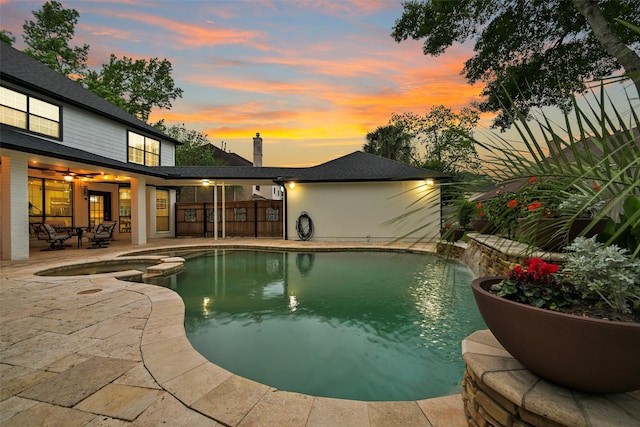 15431 Greens Cove Way, Houston, TX 77059 - pool at dusk featuring a patio, a pool with connected hot tub, and ceiling fan
