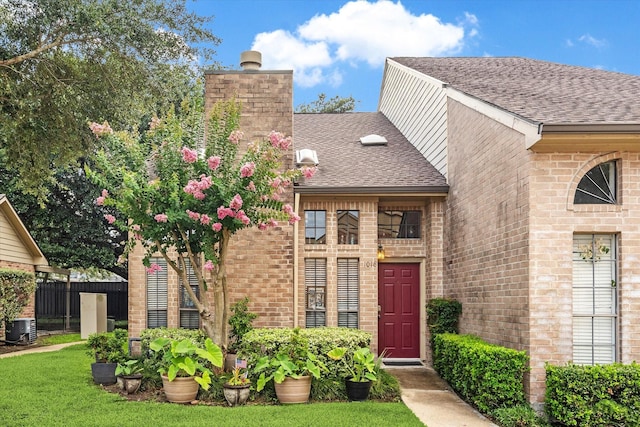 1018 Memorial Village Dr Unit 124, Houston, TX 77024 - entrance to property with a chimney, brick siding, and roof with shingles