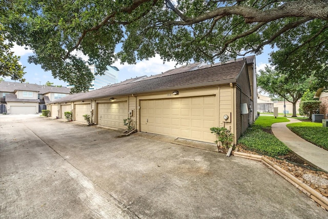1018 Memorial Village Dr Unit 124, Houston, TX 77024 - view of side of home featuring a central air condition unit and a shingled roof
