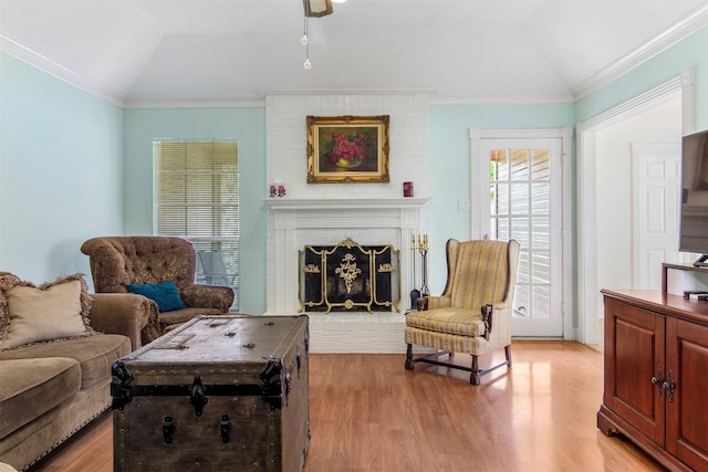 1418 Louisiana Ave, Pasadena, TX 77536 - living area featuring vaulted ceiling, light wood-type flooring, a brick fireplace, a ceiling fan, and ornamental molding