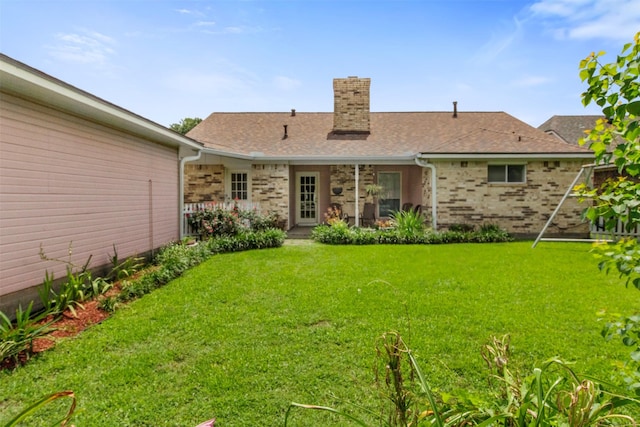 1418 Louisiana Ave, Pasadena, TX 77536 - rear view of house featuring a chimney, a yard, brick siding, and a shingled roof