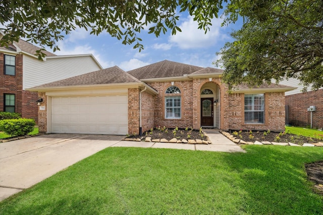 9111 Kinnel Ln, Tomball, TX 77375 - view of front facade featuring a garage, driveway, a front lawn, roof with shingles, and brick siding