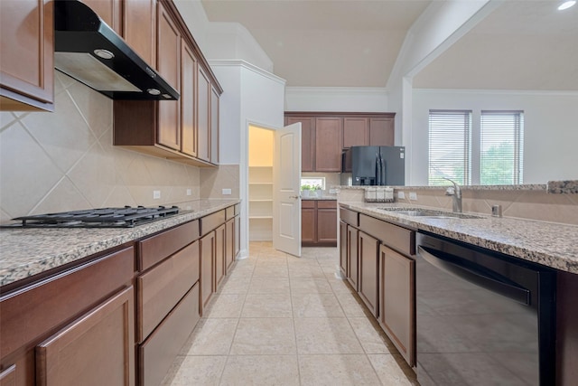 8135 W Pine Creek Bnd, Cypress, TX 77433 - kitchen with wall chimney range hood, dishwashing machine, gas cooktop, black fridge, and ornamental molding