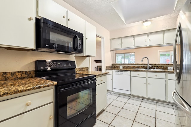4103 Bugle Rd, Houston, TX 77072 - kitchen with black appliances, dark countertops, white cabinets, light tile patterned floors, and a textured ceiling