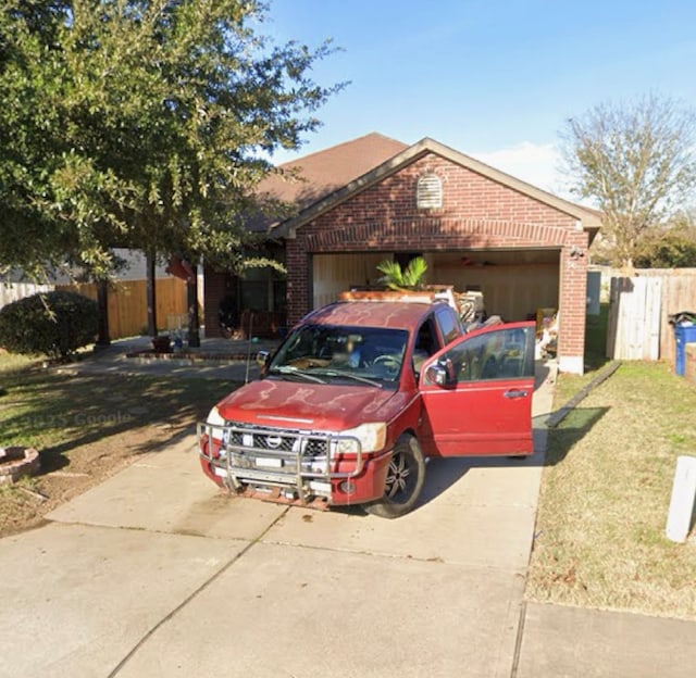 5608 Nijmegen Dr, Del Valle, TX 78617 - ranch-style home featuring brick siding, concrete driveway, and an attached garage