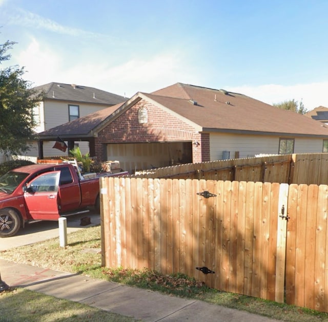 5608 Nijmegen Dr, Del Valle, TX 78617 - view of home's exterior featuring brick siding and an attached garage