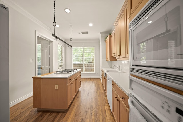 1931 Woodbury St, Houston, TX 77030 - kitchen with white appliances, crown molding, a kitchen island, recessed lighting, and light wood-style flooring