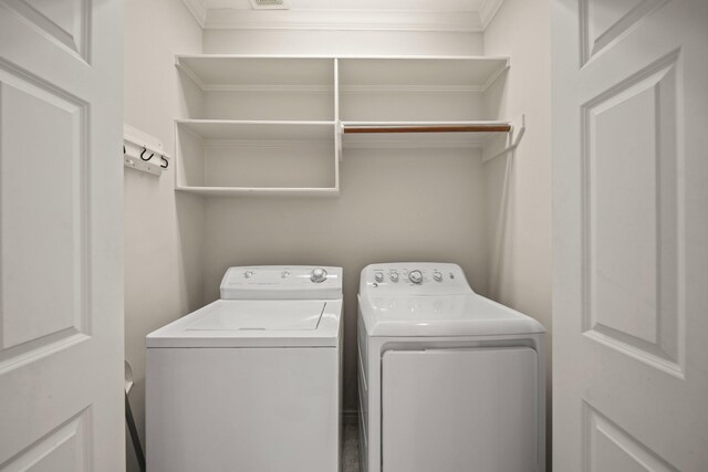 1931 Woodbury St, Houston, TX 77030 - washroom featuring washing machine and clothes dryer and crown molding