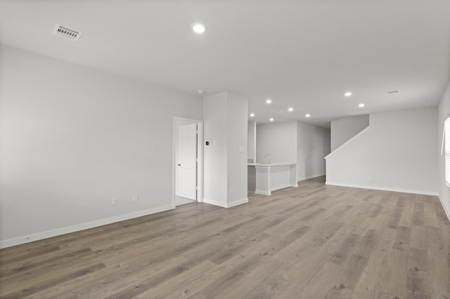 436 Shoreview Dr, Conroe, TX 77303 - unfurnished living room featuring recessed lighting and wood finished floors