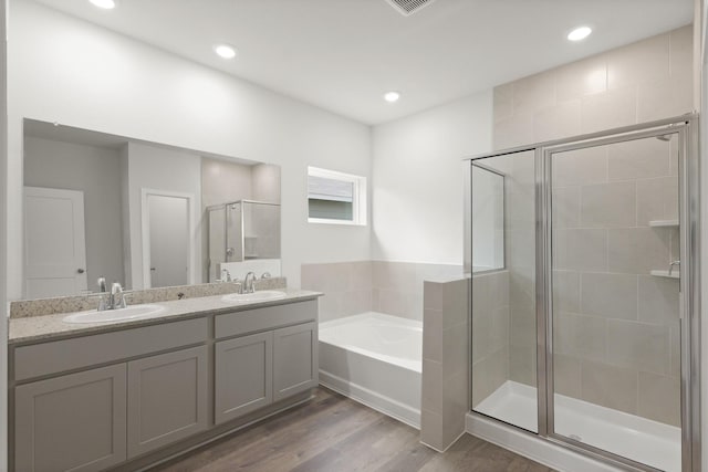 436 Shoreview Dr, Conroe, TX 77303 - full bathroom featuring a shower stall, a garden tub, double vanity, wood finished floors, and recessed lighting