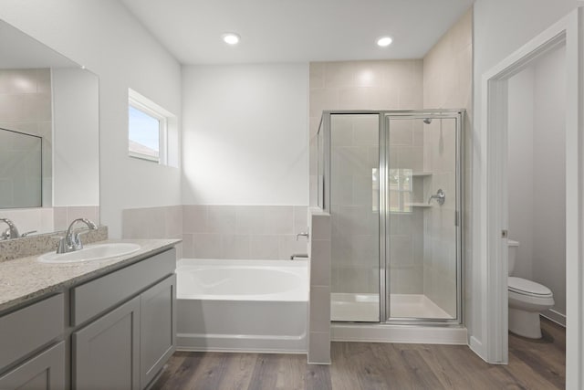 436 Shoreview Dr, Conroe, TX 77303 - bathroom featuring a bath, vanity, a stall shower, and wood finished floors