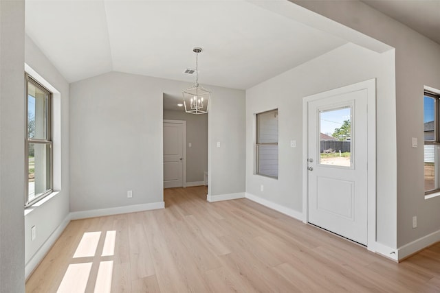2845 14th St, Hempstead, TX 77445 - unfurnished dining area featuring a chandelier, light wood-style floors, plenty of natural light, and vaulted ceiling