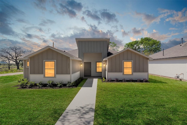 2845 14th St, Hempstead, TX 77445 - view of front of property with board and batten siding, a front lawn, and a shingled roof